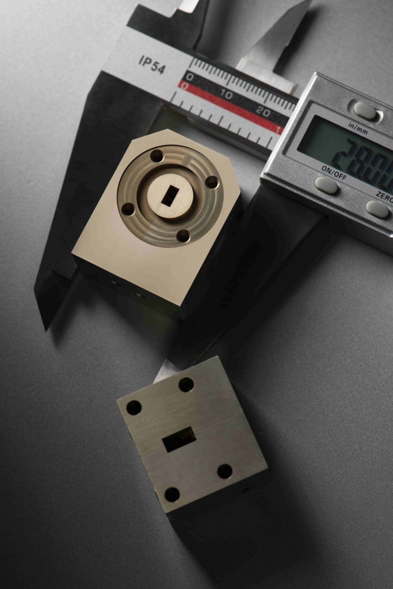 Close-up of a machined waveguide circulator block used for high‑power RF applications