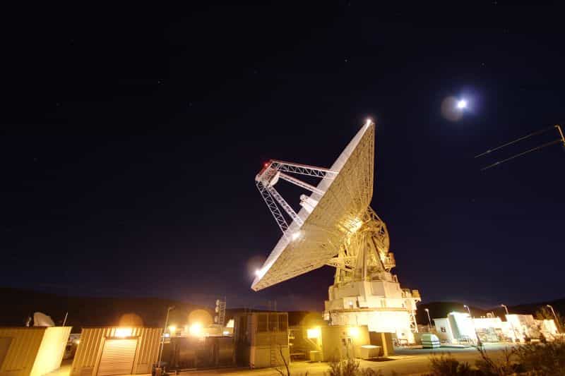 Large deep-space communications dish antenna at night